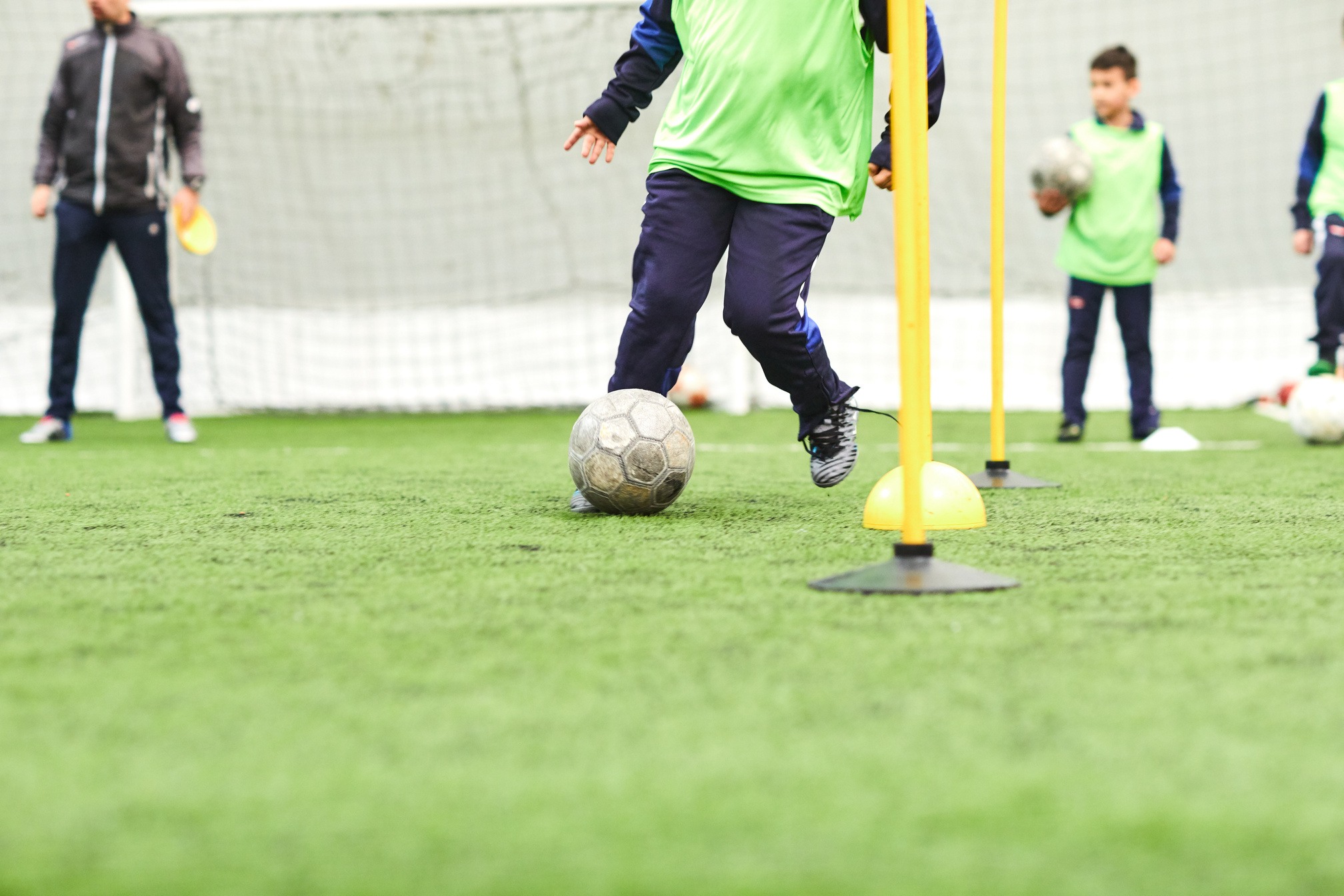 Kids Soccer Training. Indoor Soccer Players Training With Balls